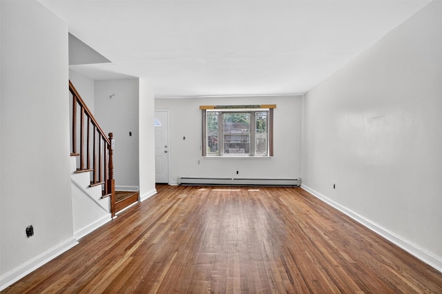 1025 E 229th St Unit B, Bronx, NY 10466 - unfurnished living room featuring a baseboard heating unit, wood finished floors, and stairway