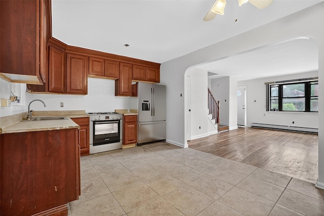 1025 E 229th St Unit B, Bronx, NY 10466 - kitchen with stainless steel appliances, baseboard heating, light countertops, ceiling fan, and light tile patterned floors