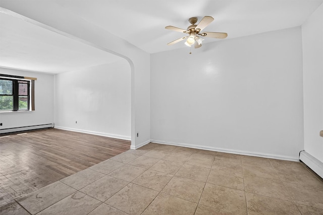 1025 E 229th St Unit B, Bronx, NY 10466 - tiled empty room with a baseboard radiator, a baseboard heating unit, ceiling fan, and arched walkways