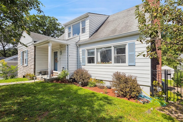 69 Ardell Rd, Bronxville, NY 10708 - view of front facade with a shingled roof, a chimney, and stone siding