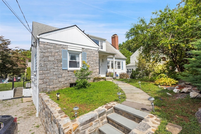 69 Ardell Rd, Bronxville, NY 10708 - view of front of property with stone siding, a chimney, and roof with shingles