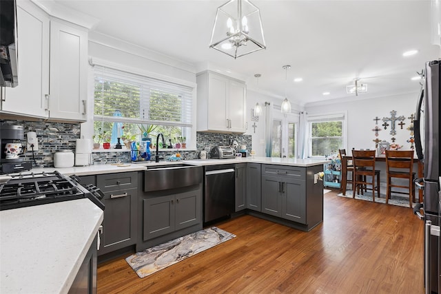 69 Ardell Rd, Bronxville, NY 10708 - kitchen with appliances with stainless steel finishes, a peninsula, gray cabinetry, decorative backsplash, and crown molding