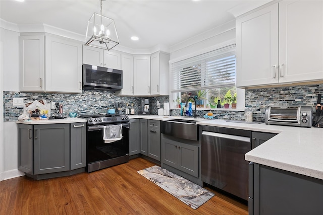 69 Ardell Rd, Bronxville, NY 10708 - kitchen featuring stainless steel appliances, gray cabinetry, a chandelier, wood finished floors, and recessed lighting