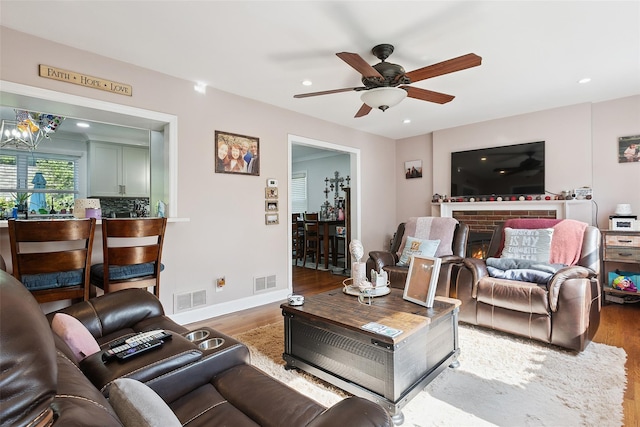 69 Ardell Rd, Bronxville, NY 10708 - living area with wood finished floors, a ceiling fan, recessed lighting, a chandelier, and a brick fireplace