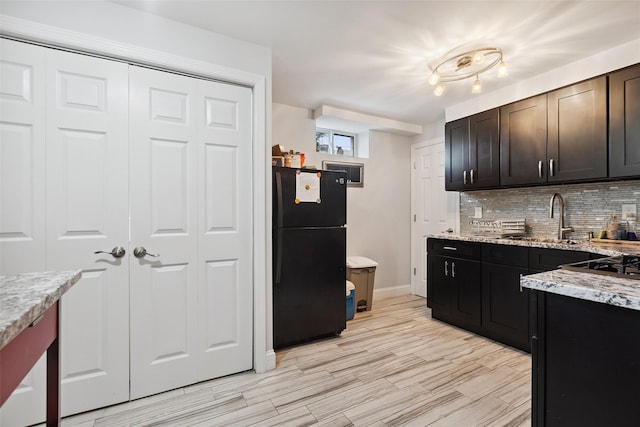 69 Ardell Rd, Bronxville, NY 10708 - kitchen featuring freestanding refrigerator, tasteful backsplash, light stone countertops, light wood-style flooring, and dark brown cabinetry