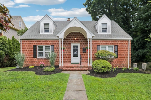 4 Aldine Park, Nyack, NY 10960 - cape cod home featuring brick siding, roof with shingles, and a front yard