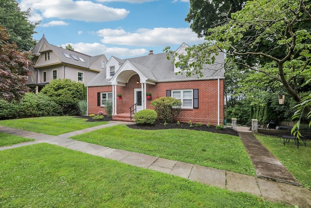 4 Aldine Park, Nyack, NY 10960 - cape cod house featuring brick siding, a front lawn, and roof with shingles