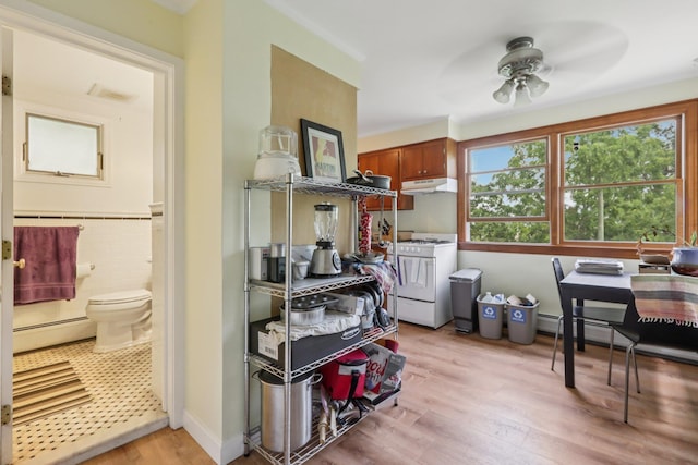 4 Aldine Park, Nyack, NY 10960 - kitchen featuring white gas stove, a baseboard radiator, under cabinet range hood, and plenty of natural light