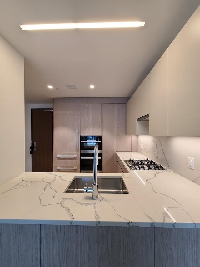 133-27 39th Ave, Flushing, NY 11354 - kitchen featuring gas cooktop, double oven, decorative backsplash, light stone countertops, and recessed lighting
