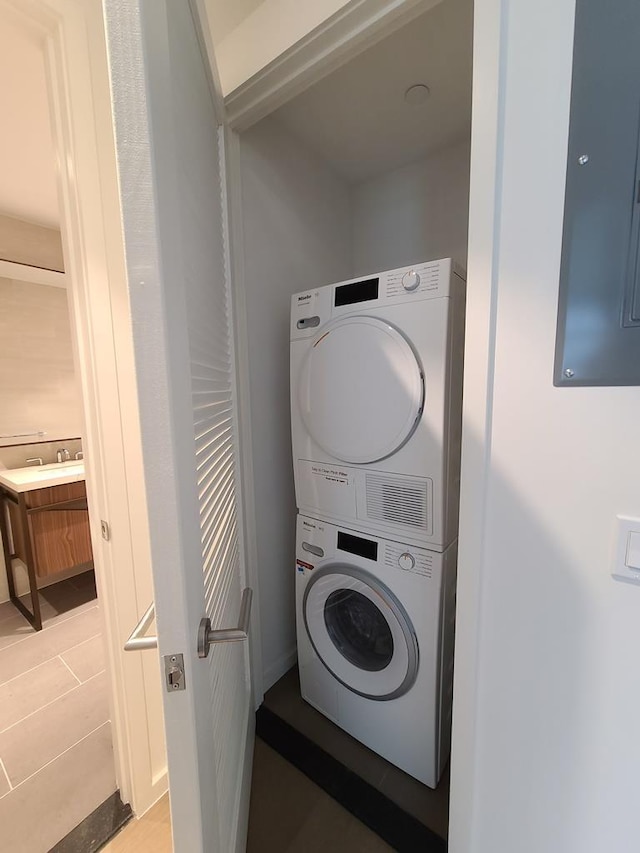 133-27 39th Ave, Flushing, NY 11354 - laundry room featuring estacked washer and dryer, electric panel, and light tile patterned floors