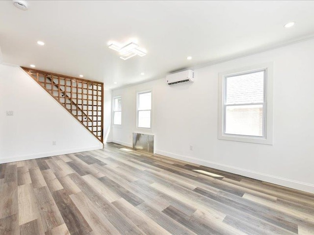 180 Evelyn Rd, Mineola, NY 11501 - unfurnished living room with a wall unit AC, stairway, recessed lighting, and wood finished floors