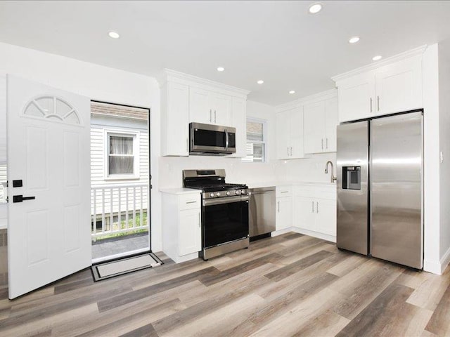 180 Evelyn Rd, Mineola, NY 11501 - kitchen featuring stainless steel appliances, light wood-style flooring, white cabinetry, light countertops, and recessed lighting