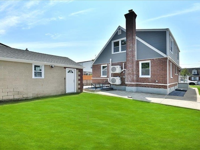 180 Evelyn Rd, Mineola, NY 11501 - back of property with a chimney and brick siding