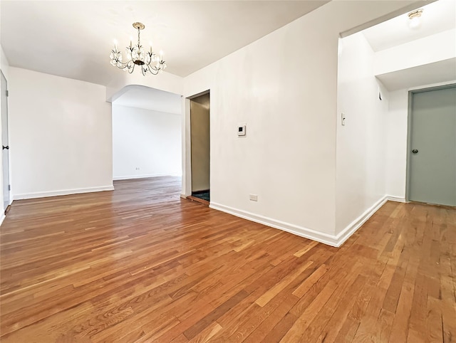 1480 Thieriot Ave Unit 5L, Bronx, NY 10460 - spare room with light wood-style flooring, a chandelier, and arched walkways