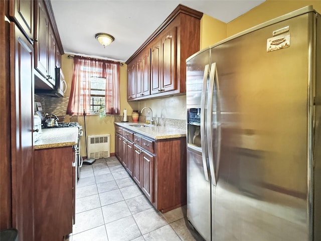 1480 Thieriot Ave Unit 5L, Bronx, NY 10460 - kitchen with appliances with stainless steel finishes, radiator heating unit, light tile patterned floors, light stone countertops, and decorative backsplash