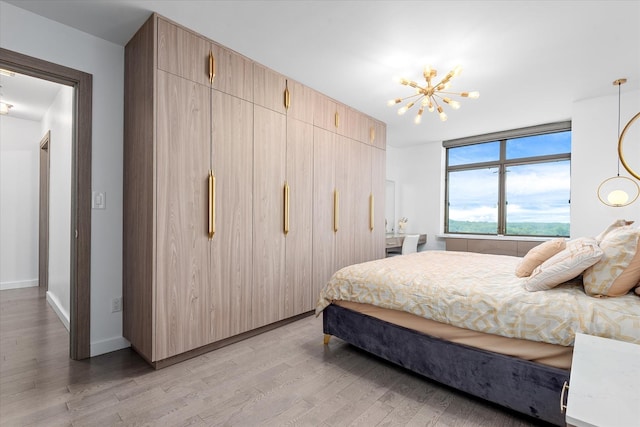 11201 Queens Blvd Unit 18D, Forest Hills, NY 11375 - bedroom with light wood-style floors and a chandelier