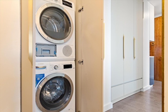 11201 Queens Blvd Unit 18D, Forest Hills, NY 11375 - washroom featuring stacked washer / drying machine and light wood-style floors