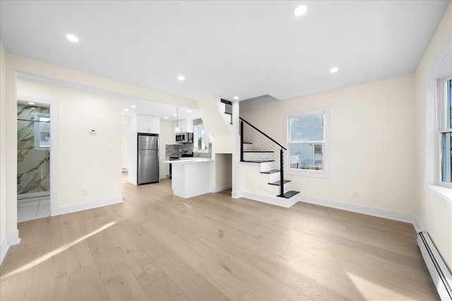 247 N Greene Ave, Lindenhurst, NY 11757 - unfurnished living room with baseboard heating, light wood-type flooring, stairway, and recessed lighting
