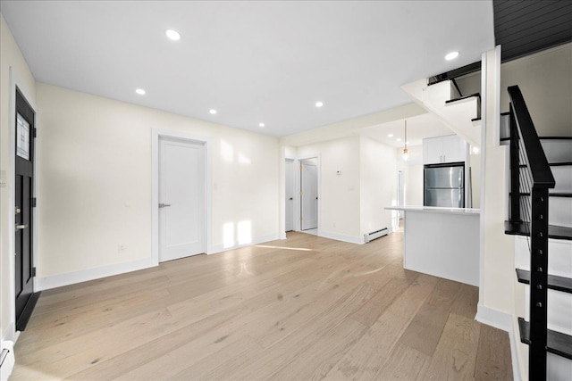 247 N Greene Ave, Lindenhurst, NY 11757 - unfurnished living room featuring light wood-type flooring, baseboard heating, recessed lighting, and stairway