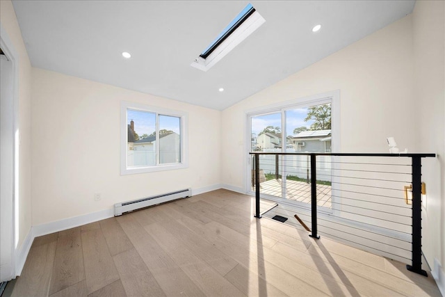 247 N Greene Ave, Lindenhurst, NY 11757 - empty room with a baseboard heating unit, a skylight, wood finished floors, vaulted ceiling, and recessed lighting