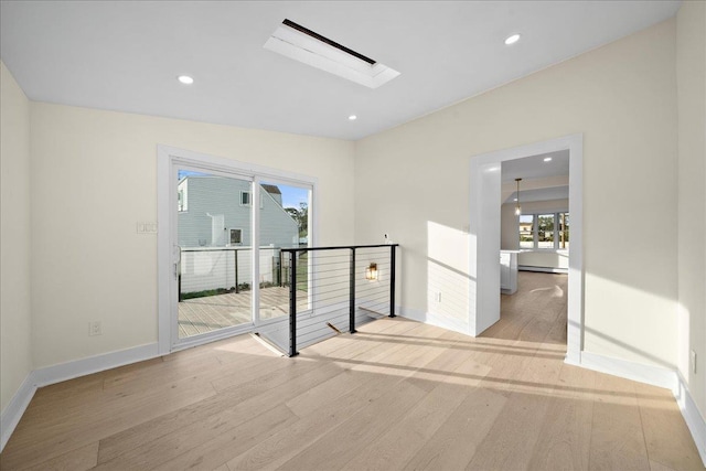 247 N Greene Ave, Lindenhurst, NY 11757 - unfurnished room featuring wood finished floors, recessed lighting, and a skylight