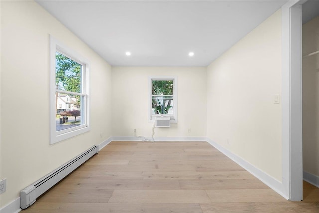 247 N Greene Ave, Lindenhurst, NY 11757 - unfurnished room featuring baseboard heating, plenty of natural light, light wood-type flooring, recessed lighting, and a wall unit AC