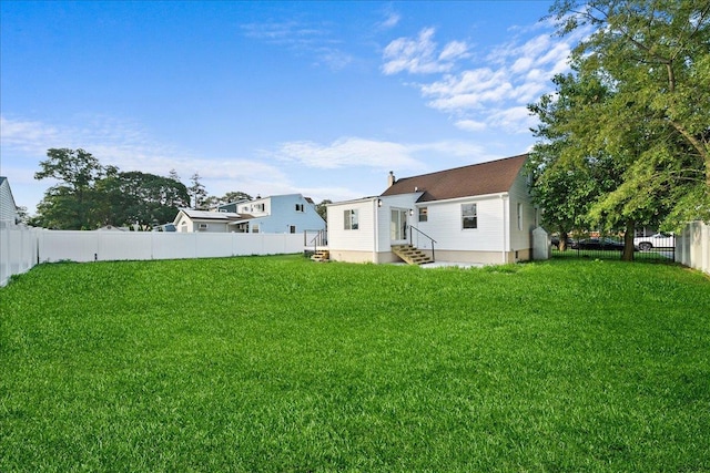 247 N Greene Ave, Lindenhurst, NY 11757 - rear view of house with entry steps and a fenced backyard