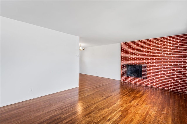 19 Dakota St, Hicksville, NY 11801 - unfurnished living room featuring wood finished floors and a fireplace