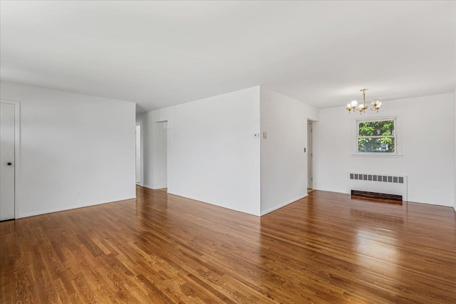 19 Dakota St, Hicksville, NY 11801 - unfurnished living room with radiator, a chandelier, and wood finished floors