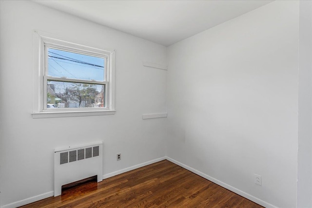 19 Dakota St, Hicksville, NY 11801 - spare room with radiator heating unit and dark wood-type flooring