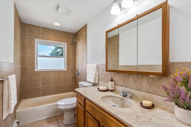 19 Dakota St, Hicksville, NY 11801 - bathroom featuring vanity, tile walls, washtub / shower combination, a baseboard radiator, and tile patterned flooring