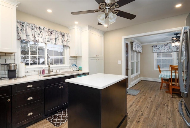 86 Shepherd Ln, Levittown, NY 11756 - kitchen with a ceiling fan, white cabinetry, tasteful backsplash, light countertops, and light wood-style floors