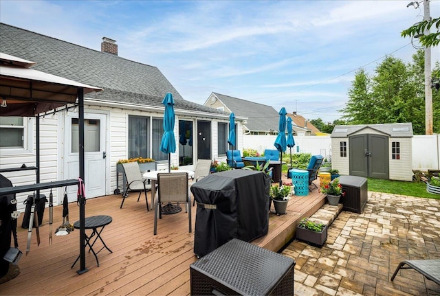 86 Shepherd Ln, Levittown, NY 11756 - deck featuring outdoor dining space, a storage shed, area for grilling, and a patio