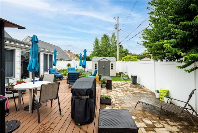 86 Shepherd Ln, Levittown, NY 11756 - wooden deck with outdoor dining area, a storage shed, a fenced backyard, area for grilling, and a patio area