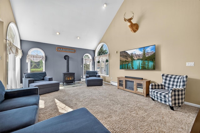 182 Otter Rd, Campbell Hall, NY 10916 - carpeted living room featuring plenty of natural light, high vaulted ceiling, a wood stove, a baseboard radiator, and a baseboard heating unit