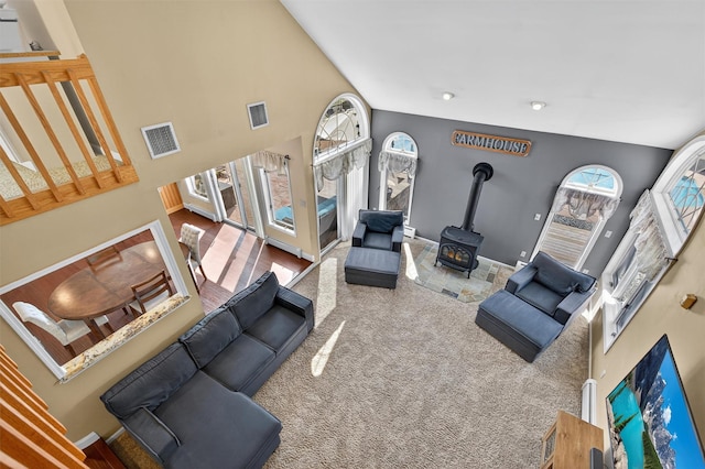 182 Otter Rd, Campbell Hall, NY 10916 - living area with a wood stove, carpet, and a high ceiling