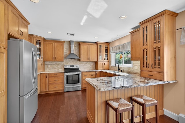182 Otter Rd, Campbell Hall, NY 10916 - kitchen with appliances with stainless steel finishes, wall chimney range hood, a peninsula, dark wood-style floors, and light stone counters