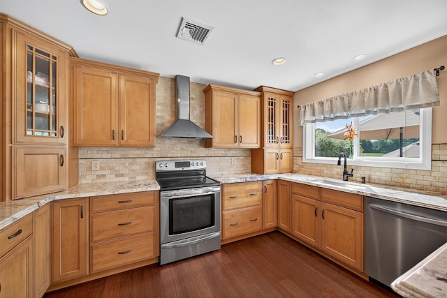 182 Otter Rd, Campbell Hall, NY 10916 - kitchen with wall chimney exhaust hood, appliances with stainless steel finishes, dark wood-style floors, light stone counters, and glass insert cabinets