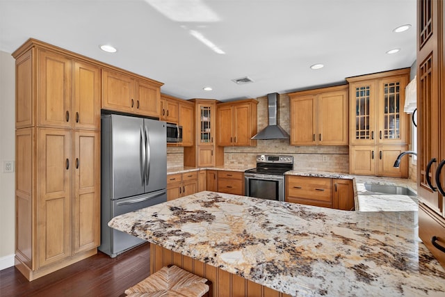 182 Otter Rd, Campbell Hall, NY 10916 - kitchen featuring wall chimney range hood, stainless steel appliances, dark wood-style flooring, light stone counters, and a peninsula