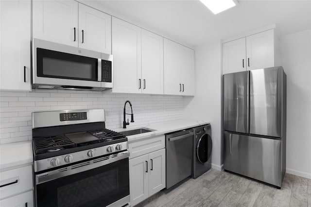 75-02 Springfield Blvd Fl 2Nd, Bayside, NY 11364 - kitchen with stainless steel appliances, washer / clothes dryer, light stone counters, and backsplash
