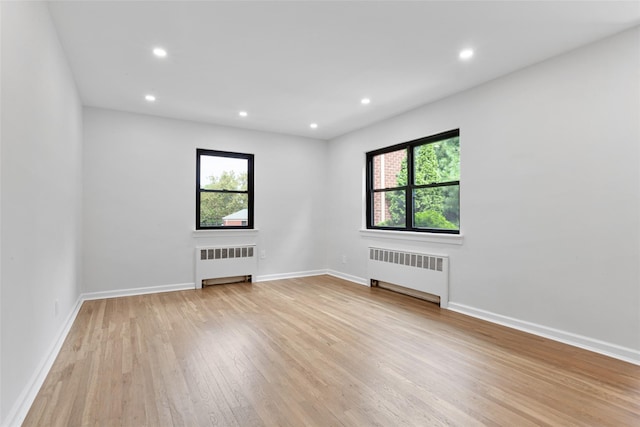 75-02 Springfield Blvd Fl 2Nd, Bayside, NY 11364 - unfurnished room with radiator heating unit, light wood-style floors, and recessed lighting