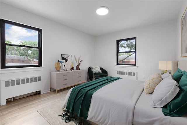 75-02 Springfield Blvd Fl 2Nd, Bayside, NY 11364 - bedroom with radiator heating unit and light wood-style floors