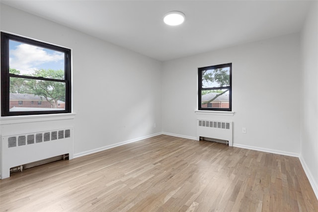 75-02 Springfield Blvd Fl 2Nd, Bayside, NY 11364 - spare room featuring radiator heating unit and light wood-style flooring