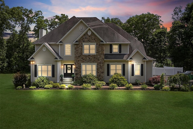 15 E Salem Rd, Fishkill, NY 12524 - view of front of house with stone siding, a chimney, a lawn, and roof with shingles