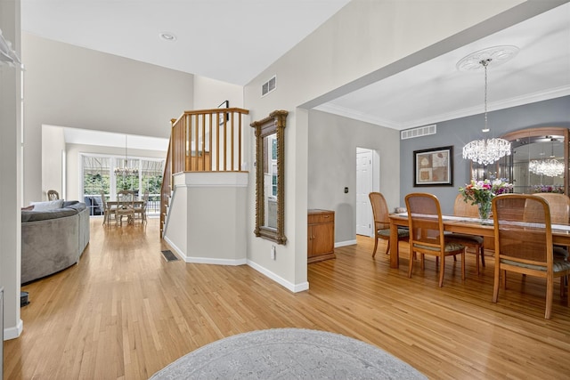 15 E Salem Rd, Fishkill, NY 12524 - dining room with a chandelier, light wood-type flooring, a towering ceiling, and ornamental molding