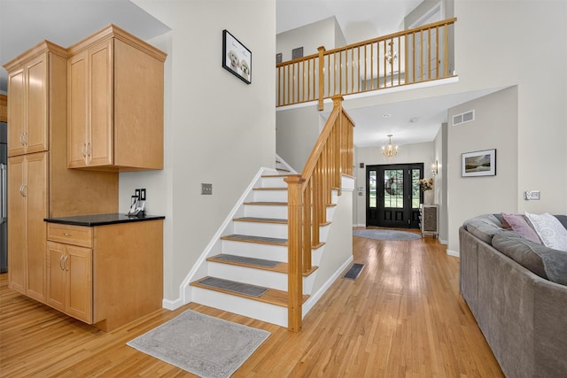 15 E Salem Rd, Fishkill, NY 12524 - stairway featuring wood finished floors, a chandelier, and a towering ceiling