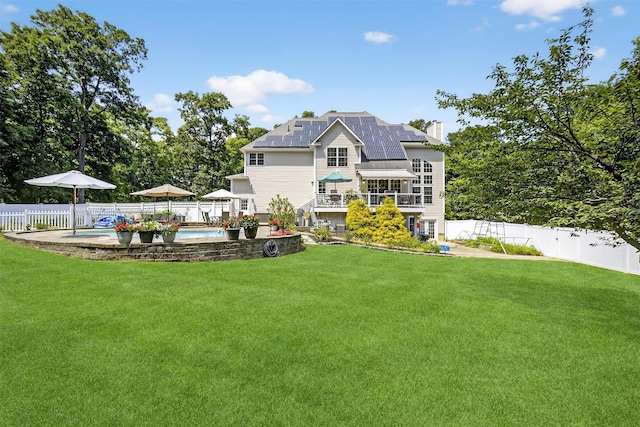 15 E Salem Rd, Fishkill, NY 12524 - rear view of house featuring a fenced backyard, a chimney, and roof mounted solar panels