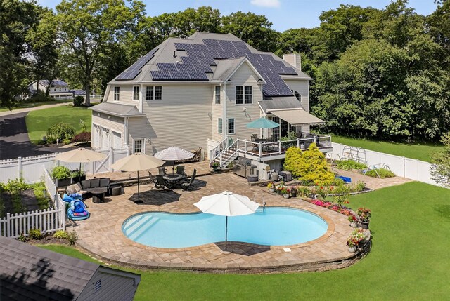 15 E Salem Rd, Fishkill, NY 12524 - rear view of property with outdoor dining area, a fenced backyard, an outdoor living space, roof mounted solar panels, and a deck