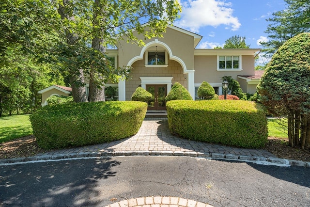 10 Faulkner Ln, Dix Hills, NY 11746 - view of front of house with french doors and stucco siding