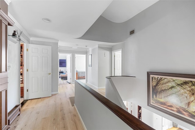 10 Faulkner Ln, Dix Hills, NY 11746 - hallway with an upstairs landing, light wood finished floors, and crown molding